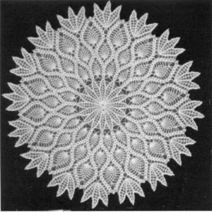 May include: A white crocheted doily with a circular design featuring a repeating pattern of leaves and flowers.