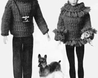 May include: Knitted doll clothes for a doll couple. The woman's sweater has a fringe trim and she is holding a bouquet of flowers. The man's sweater has a turtleneck and he is wearing a camera around his neck. A small dog is standing next to the couple.
