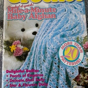 May include: A magazine cover for Crochet Digest, Spring 1995, featuring a blue crocheted baby blanket with a white teddy bear and flowers. The cover text reads "Crochet it quick! Mile-a-Minute Baby Afghan" and "More Than 20 Patterns!"