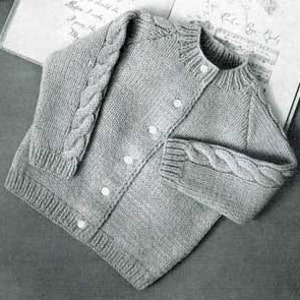 May include: A gray knitted cardigan with a cable knit pattern on the sleeves and a button closure.