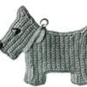 May include: A grey crocheted dog keyring with black eyes and a silver ring.