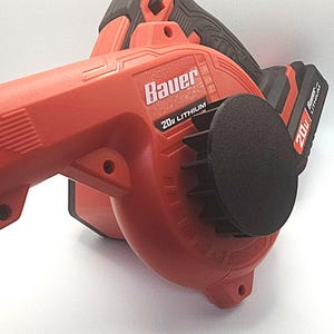 May include: A red and black Bauer 20V Lithium cordless leaf blower. The blower has a black nozzle and a black handle. The Bauer logo and 20V Lithium text are visible on the side of the blower.