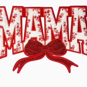 May include: Red felt applique with the word "MAMA" in white letters with a red bow in the centre.