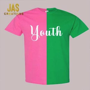 May include: A short-sleeved t-shirt, split vertically into pink and green halves. The word "Youth" is printed in white script across the center. The "JAS CREATIONS" logo is in the upper left corner.