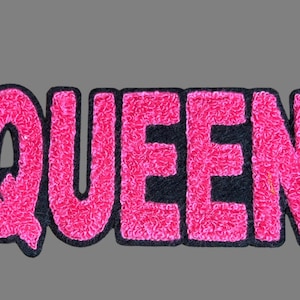 May include: Pink felt patch with the word "QUEEN" in black outlined letters.