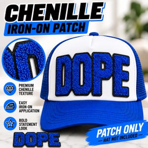 May include: A blue and white trucker hat featuring a large, textured blue chenille patch with the word DOPE in bold, black-outlined letters. The design includes a circular inset showing the fuzzy texture of the patch and text labels.