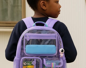 May include: A clear and purple backpack with multiple compartments, including a front pocket and side pockets. The backpack has a blue rectangular pocket and a small keychain. The word "WATERPROOF" is visible at the top.