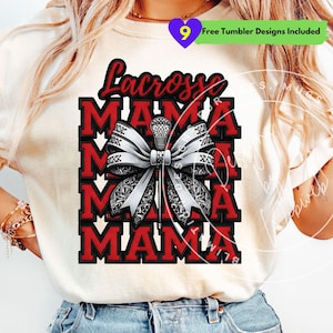May include: A cream-coloured t-shirt with a lacrosse design. The design features the word "Lacrosse" in red script above the word "MAMA" repeated multiple times in a stacked layout. A lacrosse stick and bow are in the centre.