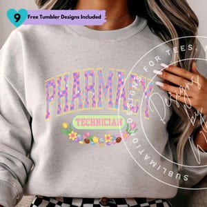 May include: A light gray sweatshirt featuring the word "PHARMACY" in a colorful, checkered design with Easter bunny accents. Below, the word "TECHNICIAN" is displayed in a green oval, surrounded by flowers and Easter eggs.