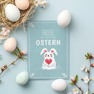 Tarjeta de Pascua: Conejito con corazón, tarjeta de felicitación primaveral azul con sobre, formato A6, un bonito regalo para familiares o seres queridos.