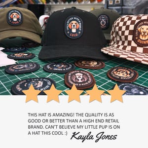 May include: A black baseball cap with a patch that reads "Life's Better With A Beagle" and the name "Lulu". The cap is surrounded by several patches featuring dogs and the text "Life's Better With A Beagle".