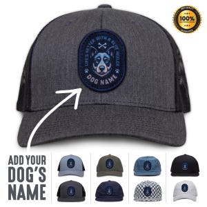 May include: A black and gray trucker hat with a blue and white patch featuring a blue heeler dog. The patch says "Life's Better With A Blue Heeler" and has a space for a dog's name.