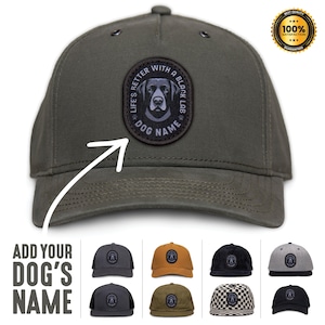 May include: A green baseball cap with a black patch featuring a black labrador retriever and the text "Life's Better With A Black Lab" and "Dog Name".