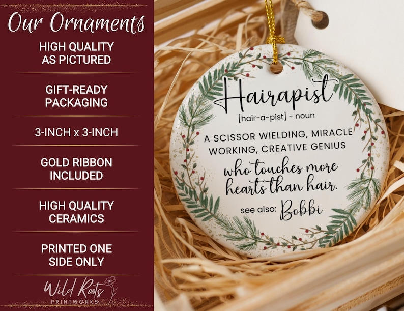 May include: A white ceramic ornament, 3-inch by 3-inch, with the word "Hairapist" and a definition printed on it. The ornament has a gold ribbon for hanging and is decorated with a green and red floral design. The text reads "who touches more hearts than hair."