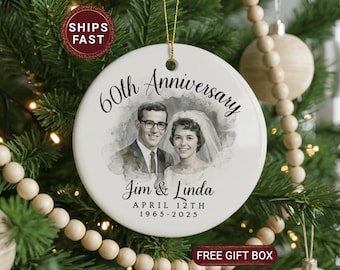 May include: A white ceramic Christmas ornament with a gold string, featuring a black and white photo of a couple. The ornament reads "60th Anniversary" and includes the names "Jim & Linda" and the date "April 12th 1965-2025".