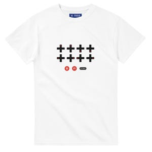 May include: White t-shirt featuring a black and red controller design. The design includes a grid of plus signs, the letters "B" and "A" in red circles, and a "START" button. The shirt has a crew neck and short sleeves.