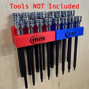 May include: A red and blue plastic tool organizer rack holding multiple metal socket bits. The red section is labeled with the text mm and the blue section is labeled with the text sae. The text Tools NOT Included is visible at the top.