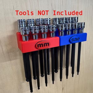 May include: A red and blue tool organizer with the text "mm" and "sae". The organizer holds a set of silver tools with black handles. The text "Tools NOT Included" is above the organizer.