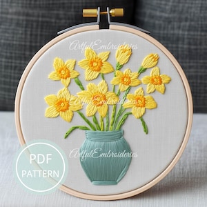 May include: A PDF pattern for embroidery of a bouquet of yellow daffodils in a green vase. The pattern is titled "Artful Embroideries".