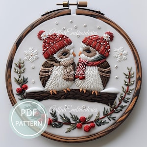 May include: Embroidered pattern of two owls wearing red Santa hats and scarves, sitting on a branch with red berries and green leaves. The owls are looking at each other. The pattern is in a round embroidery hoop with a wooden frame. The text "PDF PATTERN" is in a circle at the bottom left of the image.