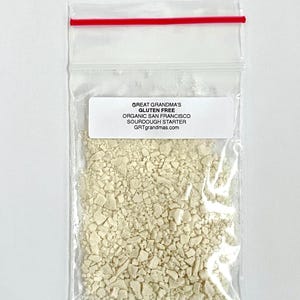 May include: A small plastic bag containing a white sourdough starter. The bag has a label that reads "Great Grandma's Gluten Free Organic San Francisco Sourdough Starter GRTgrandmas.com".
