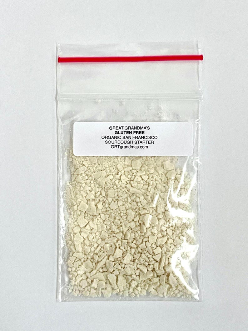 May include: A small plastic bag containing a white sourdough starter. The bag has a label that reads "Great Grandma's Gluten Free Organic San Francisco Sourdough Starter GRTgrandmas.com".