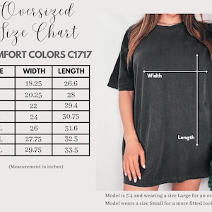 May include: An oversized t-shirt size chart with measurements in inches. The chart includes sizes S to 4XL, with corresponding width and length dimensions. A woman models the shirt, demonstrating the fit. The shirt is dark gray.