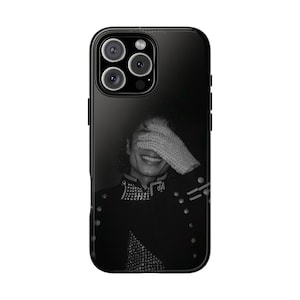 May include: Black phone case with a black and white image of a smiling person wearing a black jacket and a white glove. The phone case has a glossy finish and a camera module with three lenses.