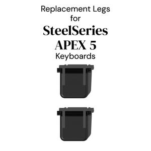 May include: Two black replacement legs for SteelSeries Apex 5 keyboards. The text "Replacement Legs for SteelSeries Apex 5 Keyboards" is displayed above the legs. The legs are rectangular with a small tab on each side.