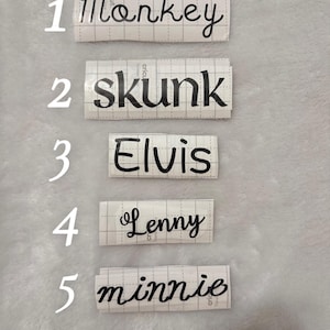 May include: Five white labels with black text. The labels are numbered 1 through 5. The text on the labels reads: 1. monkey, 2. skunk, 3. Elvis, 4. Lenny, 5. minnie.