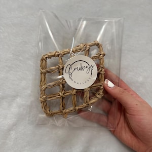 May include: A small, woven, square-shaped pet toy made of natural straw. The toy is packaged in a clear plastic bag with a white label that says "Smookeys Small Pets".