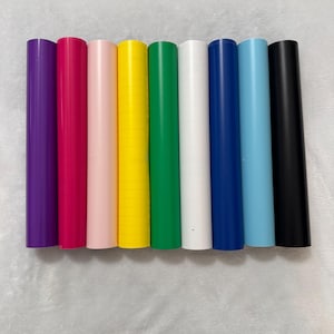 May include: Eight rolls of vinyl adhesive film in various colors, including purple, pink, light pink, yellow, green, white, blue, and black.