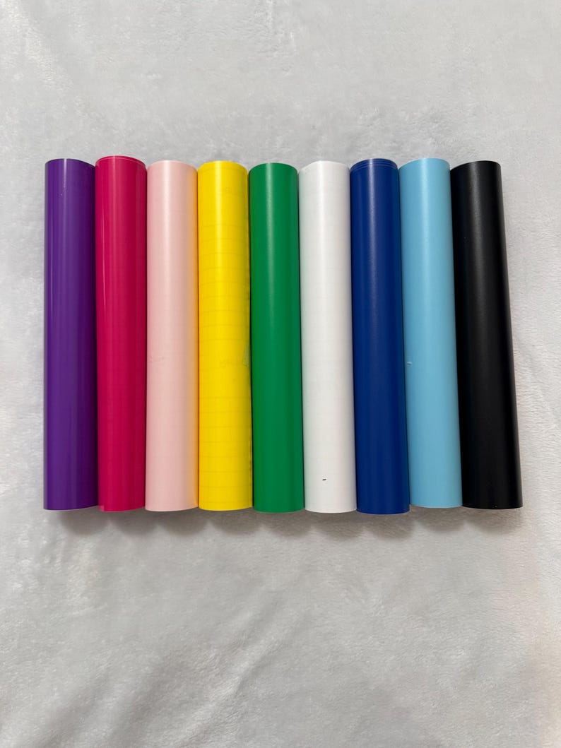 May include: Eight rolls of vinyl adhesive film in various colors, including purple, pink, light pink, yellow, green, white, blue, and black.