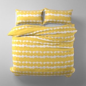 May include: A bedding set consisting of a duvet cover and two rectangular pillows, all featuring a repeating horizontal pattern of yellow scalloped or cloud-like shapes against a solid white background, viewed from directly above.