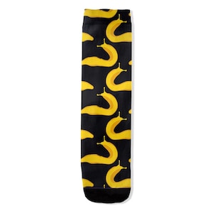 May include: A pair of black socks with a repeating pattern of yellow slugs. The socks are crew length and have a black cuff.