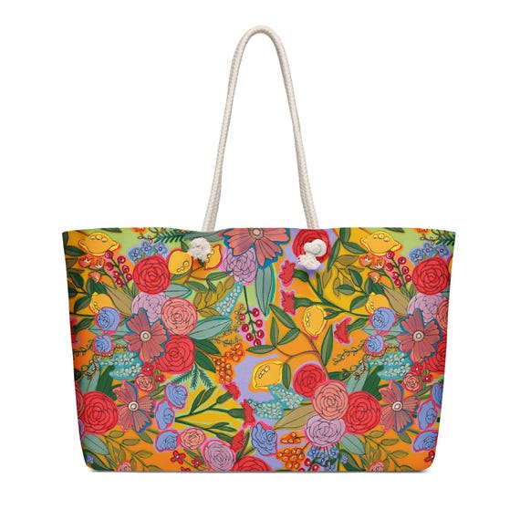 Oversized weekender bag with bright red floral art by Jrouxart