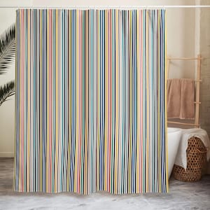 May include: A colorful shower curtain with vertical stripes in various colors, including yellow, blue, black, and red. The curtain hangs from a white rod, and the design is a repeating pattern of thin lines. The overall theme is modern and vibrant.