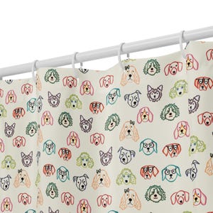 May include: A shower curtain with a repeating pattern of colorful dog faces. The dogs are outlined in black and filled with shades of pink, orange, green, and blue. The curtain hangs from a white rod with white rings.
