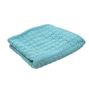 May include: Folded turquoise blanket with a repeating pattern of small, textured, scale-like shapes. The blanket is a solid color with variations in the weave creating a subtle visual texture. The edges are neatly folded, suggesting a soft, comfortable textile.