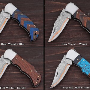 May include: Four folding pocket knives with patterned metal blades and metallic bolsters. The handles feature varied inlays: rosewood with blue wood, rosewood with wangi wood, full rosewood, and a combination of turquoise, wood, and horn materials.