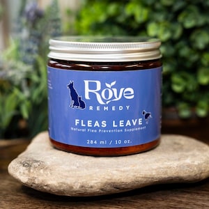 May include: A jar of Rove Remedy natural flea prevention supplement. The blue label features a dog and cat silhouette, with the words "Fleas Leave". The jar is 10 oz. and sits on a stone.