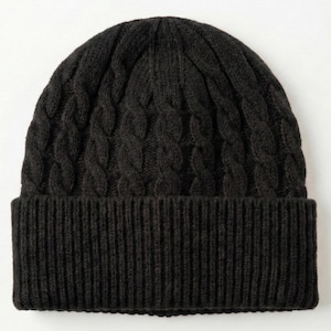 May include: A solid black knit beanie featuring a vertical cable knit pattern on the crown and a wide, ribbed cuff at the base. The hat is constructed from a thick, textured yarn, providing a consistent dark colour throughout the entire design.