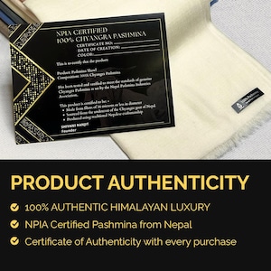 May include: A cream-colored pashmina shawl with a small black label reading 100% Pashmina, accompanied by a black NPIA certification card with gold geometric accents. The card text details 100% Chyangra Pashmina, 16 microns or less, and Nepal origin.
