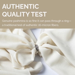May include: A cream-colored pashmina scarf pulled through a small, ornate silver-toned metal ring. The image includes the text: AUTHENTIC QUALITY TEST. Genuine pashmina is so fine it can pass through a ring&mdash;a traditional test of authentic 16-micron fibers.