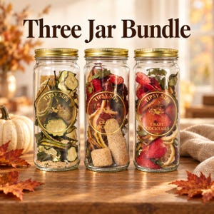 May include: Three clear glass jars with gold lids, each containing dried fruit and cocktail ingredients. Each jar features a circular label reading Tipsy Sips Craft Cocktails. The text Three Jar Bundle appears above the jars.