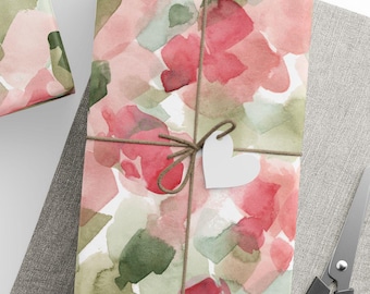 May include: Gift-wrapped presents with watercolor floral patterned paper in shades of red, pink, and green. Each package is tied with twine and a white paper tag. A ball of twine, scissors, and blank tags are also visible.