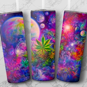 Puede incluir: Tres vasos de acero inoxidable con un diseño psicodélico de espacio y galaxia. Los vasos presentan una nebulosa colorida con planetas, estrellas y plantas verdes frondosas.