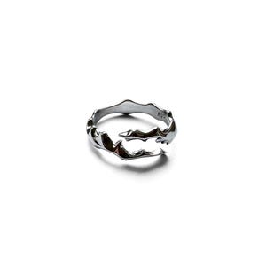 May include: A silver-colored ring with an organic, flowing design. The ring has an irregular, textured surface, with a wave-like pattern. The ring is made of a shiny, metallic material and is set against a white background.