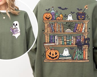 May include: Olive green sweatshirt featuring a ghost reading a book on the front and a bookshelf with Halloween-themed decorations on the back. The back design includes pumpkins, potion bottles, and a cauldron.