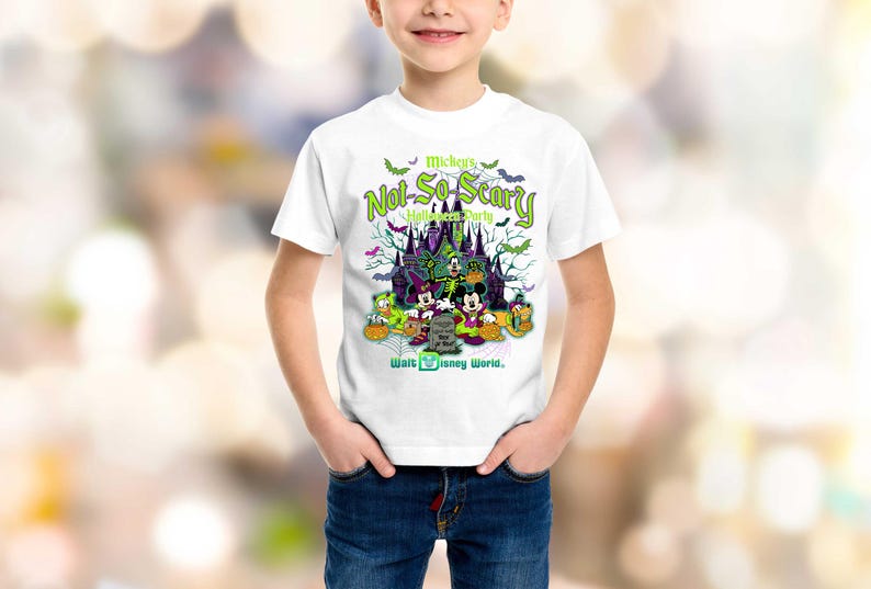May include: White t-shirt featuring a colorful graphic for Mickey's Not-So-Scary Halloween Party at Walt Disney World. The design includes Mickey Mouse, Donald Duck, and Goofy in Halloween costumes, with a spooky castle and bats.